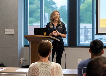 A faculty member coaching in a lecture hall.