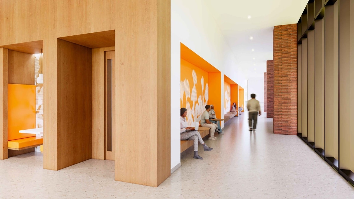Rendering of a collaborative commons inside the new Student Success Center, with wood-lined study nooks and students seated