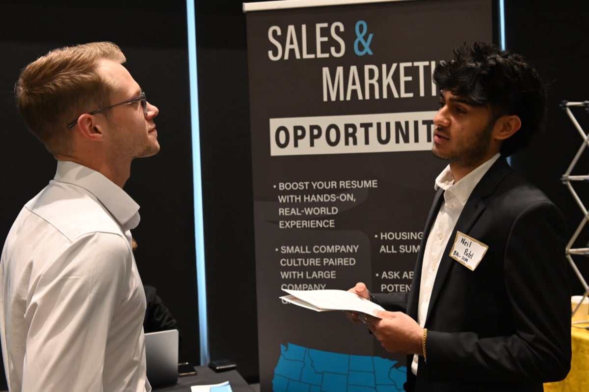 Students network with employers at a UT career fair