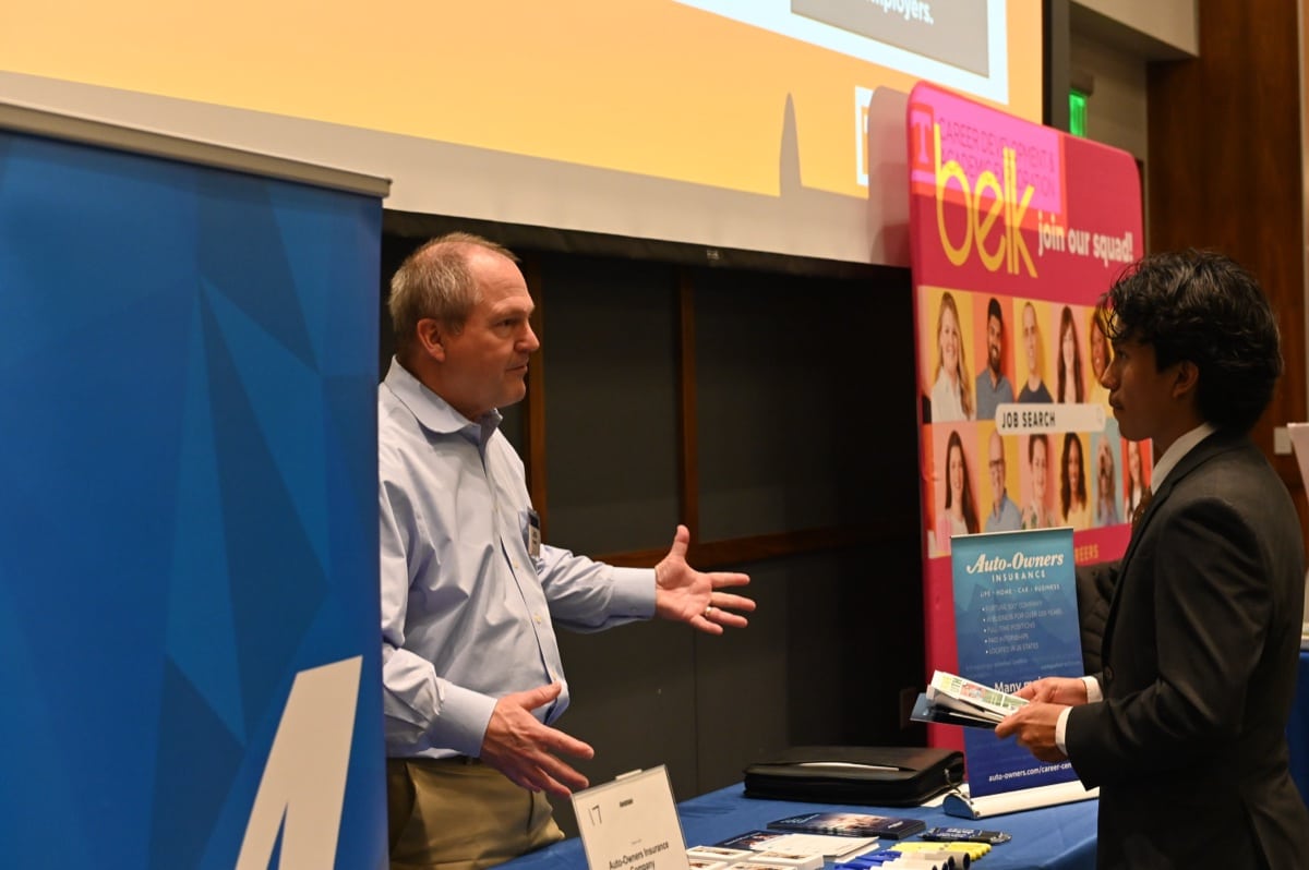 Students network with employers at a UT career fair