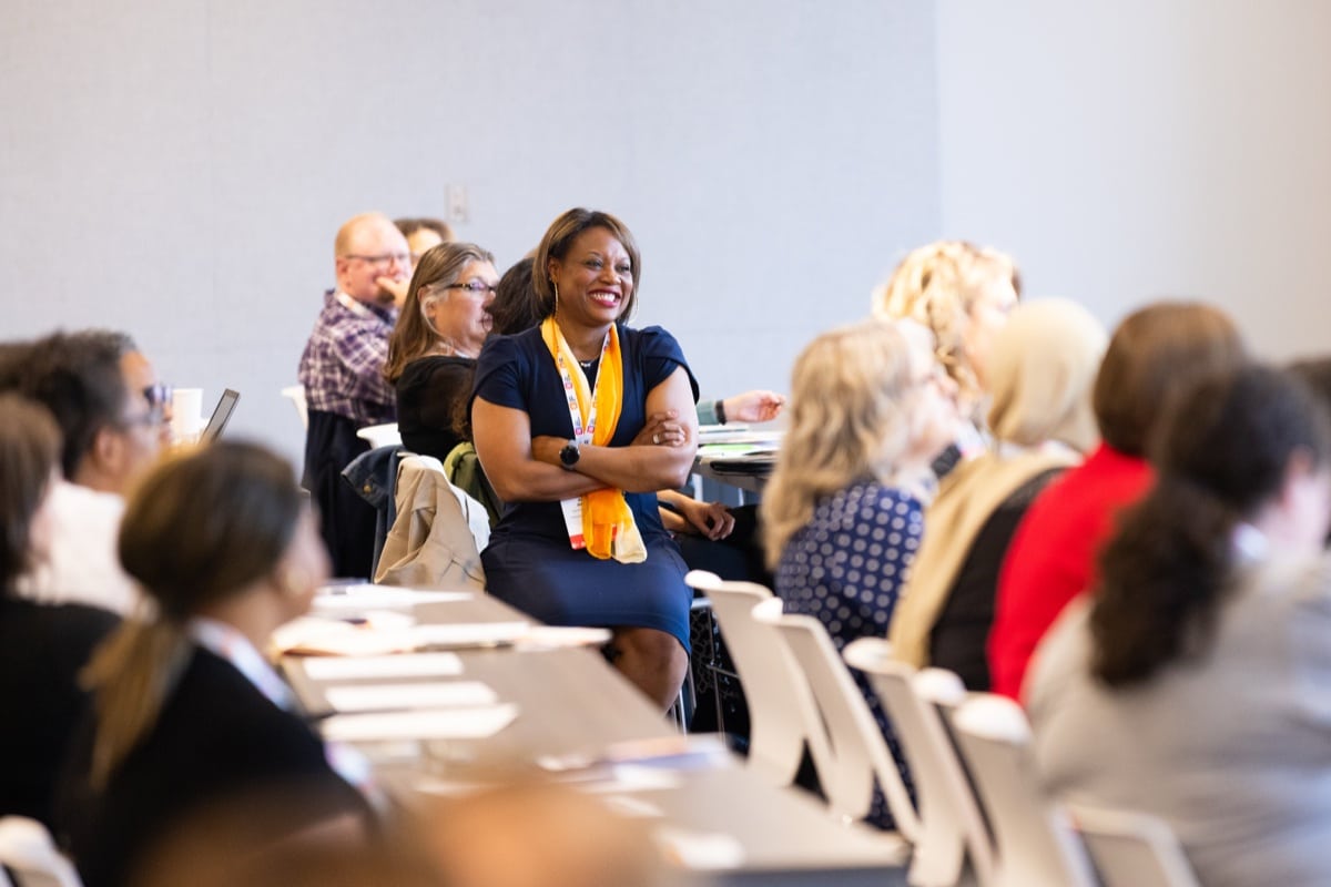 Dr. Amber Williams, Vice Provost for Student Success, smiles while seated at a Student Success conference