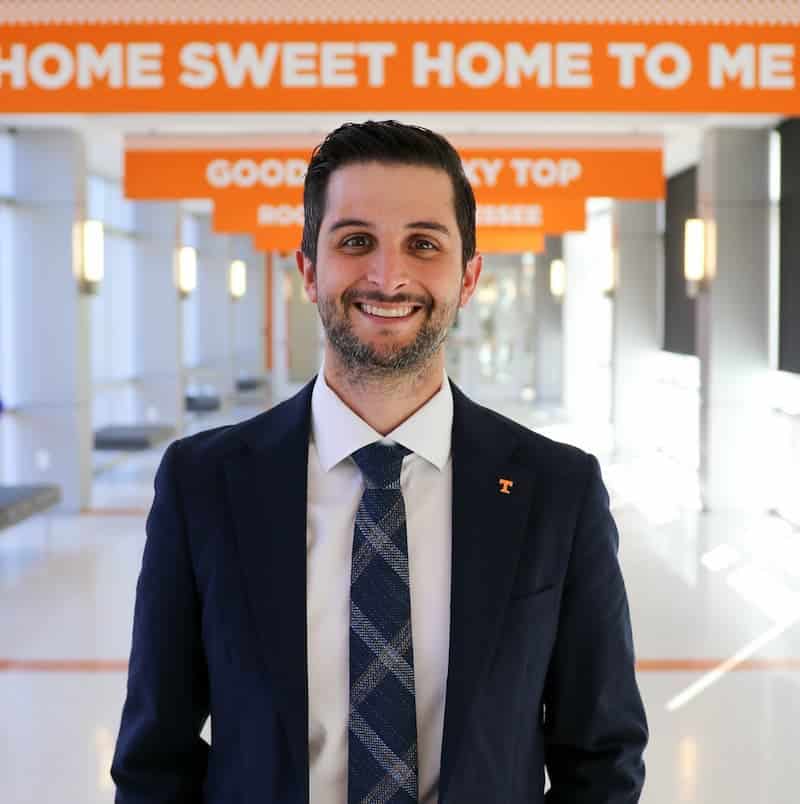 Professional headshot of Adam White